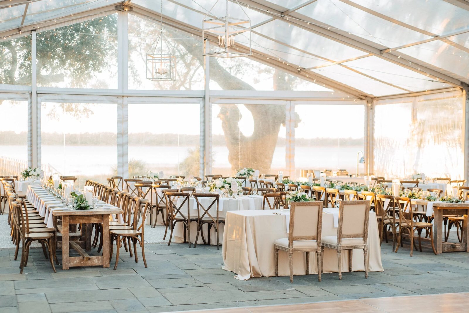 Golden-hour tented reception overlooking the water